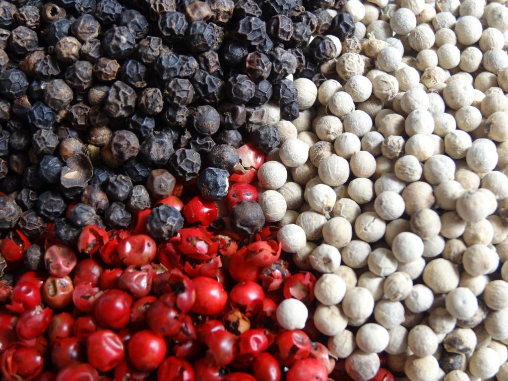 Black, red and white peppercorns 